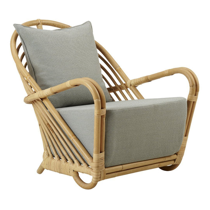 "Natural rattan chair with a soft gray cushion, featuring a sleek, modern design and minimalistic patterns."