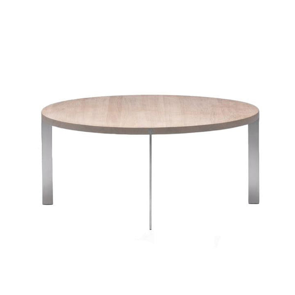 Round coffee table with a light wood top and sleek silver metal legs, showcasing a minimalist design.
