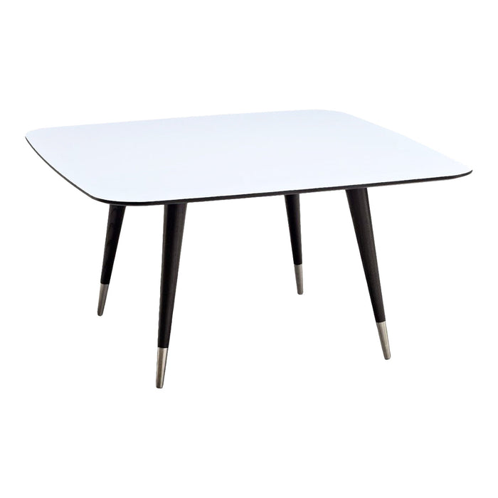 Modern rectangular table with a glossy white top and sleek black legs featuring metallic tips.