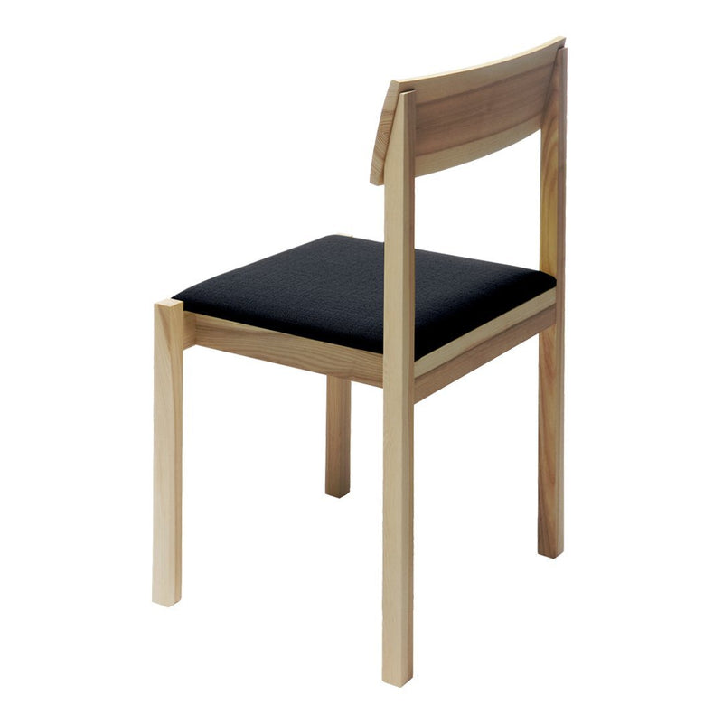 Wooden chair with a natural finish and a solid black seat cushion, featuring a minimalist design.