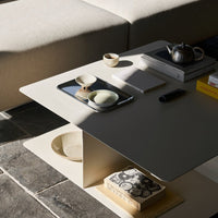 Minimalist cream coffee table with smooth surfaces, featuring soft shadows and subtle earthy tones. Perfect for modern decor.