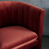 Velvet armchair in rich burgundy with vertical tufted pattern, adding elegance to any space.