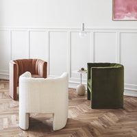Three stylish armchairs in terracotta, white, and olive green, adding modern elegance to a chic interior space.