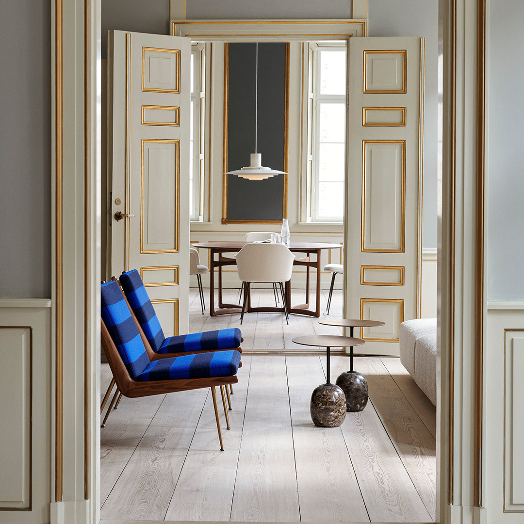 Blue and black striped chairs in a bright room with neutral tones and wooden flooring. Elegant and modern decor.