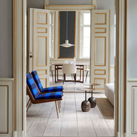 Blue and black striped chairs in a bright room with neutral tones and wooden flooring. Elegant and modern decor.