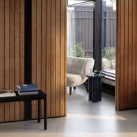 Neutral tones with rich wooden textures and sleek black accents create a modern, cozy aesthetic for interior decor.