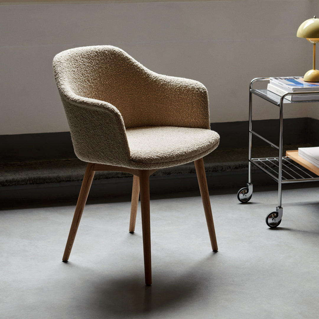 Beige textured armchair with light wooden legs, perfect for modern interiors. Elegant and stylish design.