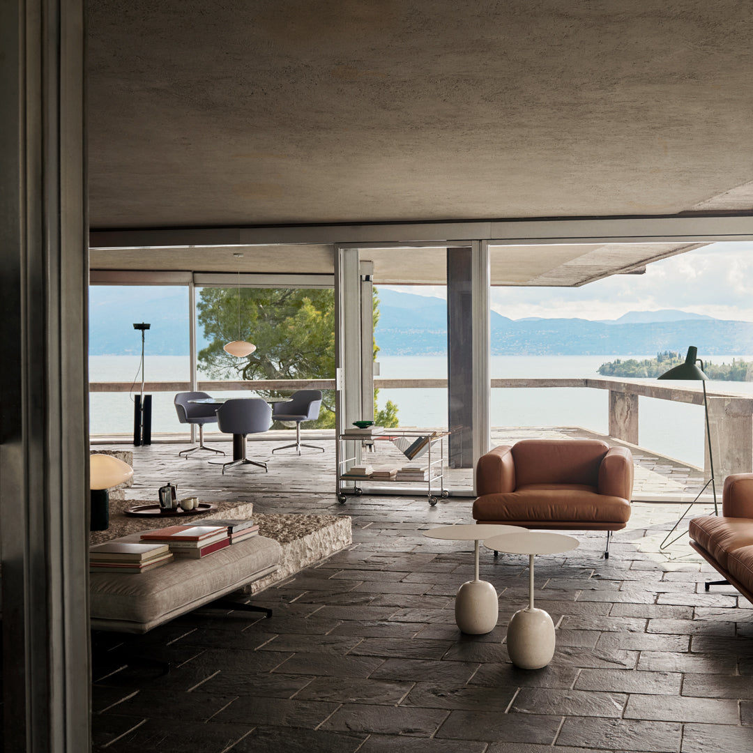 Modern living room featuring neutral tones, earthy browns, and sleek geometric patterns in a stylish outdoor setting.