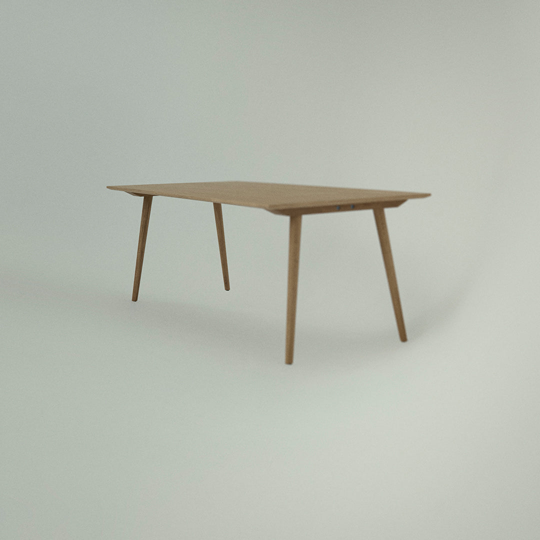 Light wood dining table with a smooth, natural finish and minimalist design, featuring tapered legs.