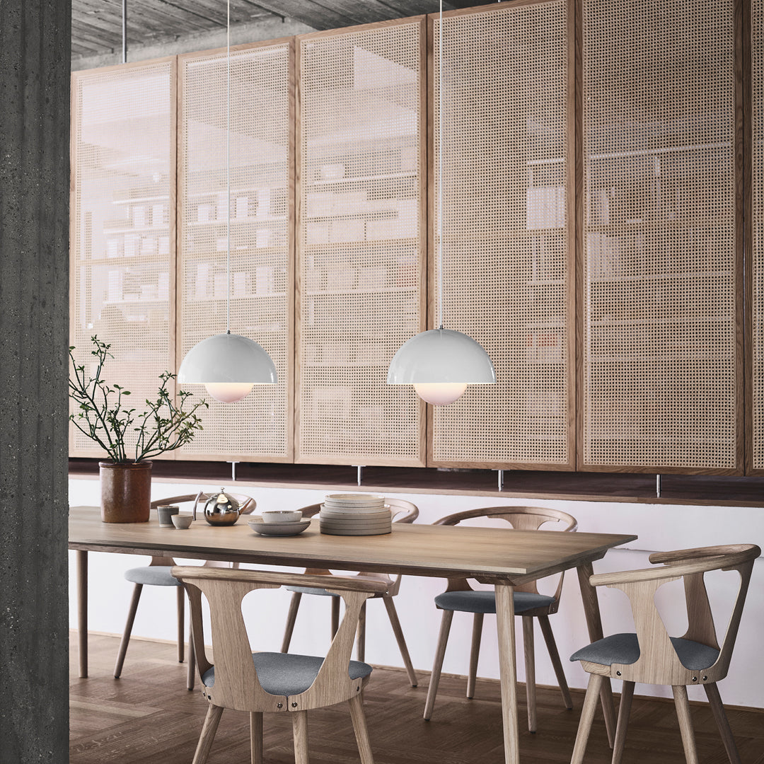 Scandinavian dining area featuring neutral tones, soft white pendant lights, and natural wood textures. Cozy and minimalist design.