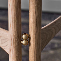Light oak wood with natural grain, featuring a sleek brass accent for a modern touch. Ideal for contemporary decor.