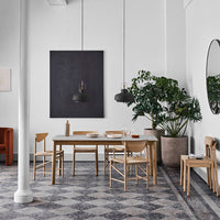 Modern dining room featuring earthy tones, geometric patterned flooring, and minimalist wooden furniture.