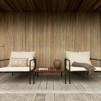 Light beige cushions with gray accents on black metal frames, set against a warm wooden background with vertical lines.
