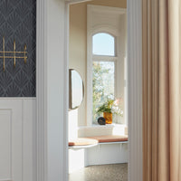 "Elegant geometric wallpaper in dark gray, paired with soft cream curtains and a natural wood accent."