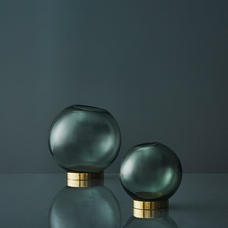"Set of two rounded glass vases in smoky gray with sleek gold bases, showcasing minimalistic elegance for modern decor."