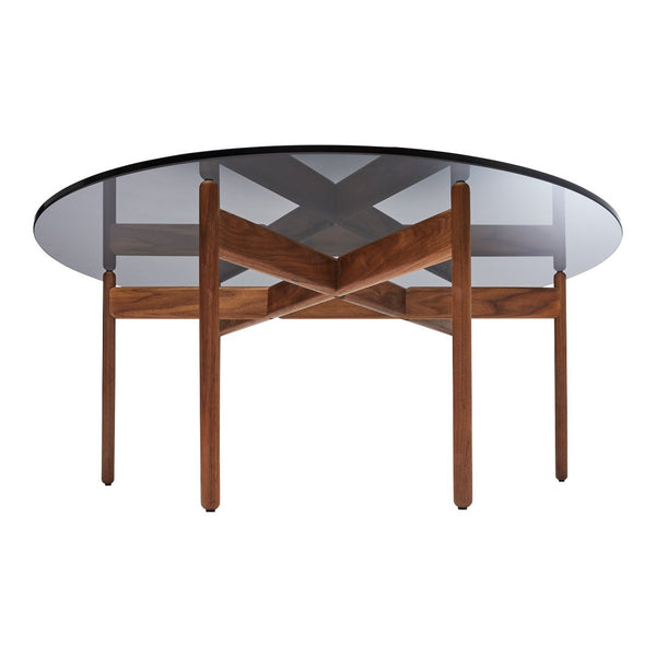 Round glass dining table with a dark wooden base featuring a modern cross pattern. Elegant and contemporary design.