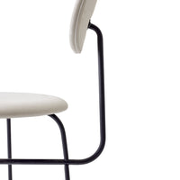 Light beige chair with a minimalist design, featuring a sleek black metal frame.
