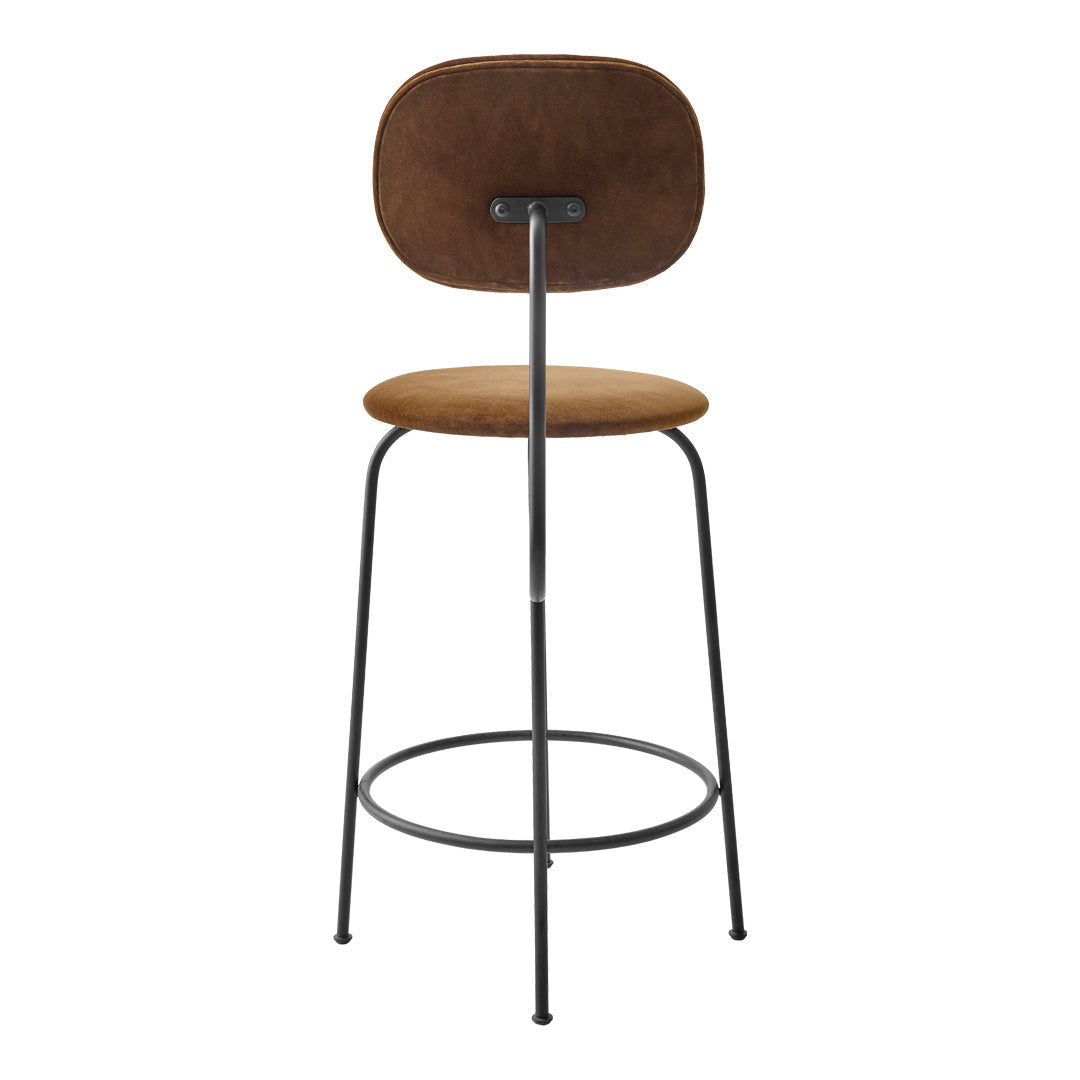 Brown suede bar stool with a minimalist design and black metal frame. Simple, modern aesthetic suitable for any decor.