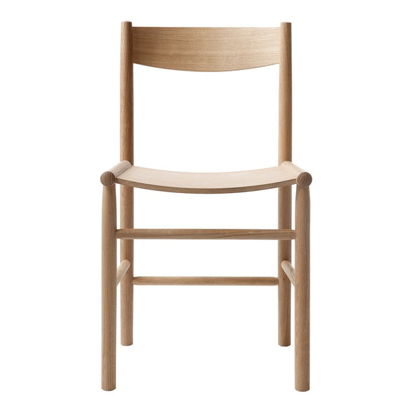 Light natural wood chair with a minimalist design and smooth, clean lines. Perfect for modern decor.