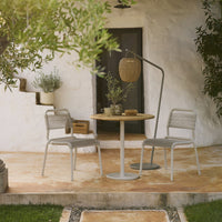 Neutral-toned patio furniture with a natural wood table, featuring sleek gray chairs and a minimalist design.