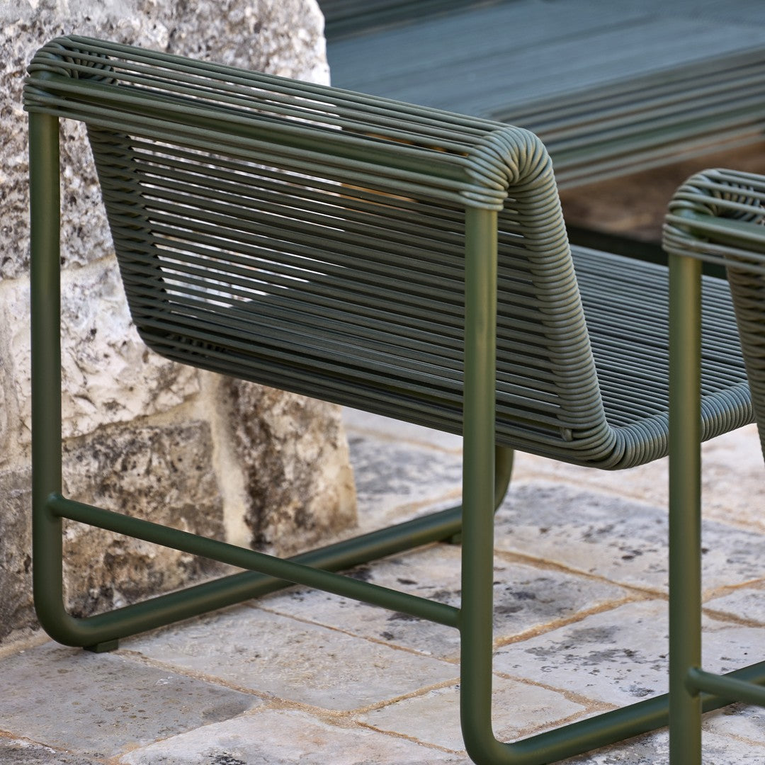 "Modern green patio chair with a sleek, striped design and sturdy metal frame."