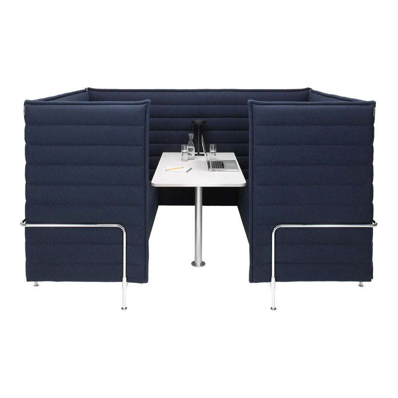 Navy blue padded privacy booth with sleek white table, featuring a modern and minimalistic design.