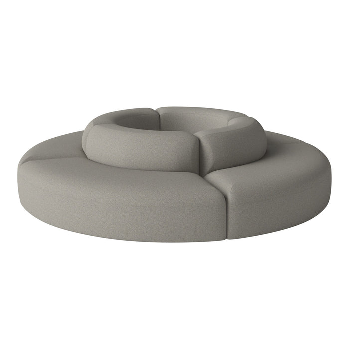 Circular gray sofa with smooth, textured fabric and modern contours, perfect for contemporary decor.