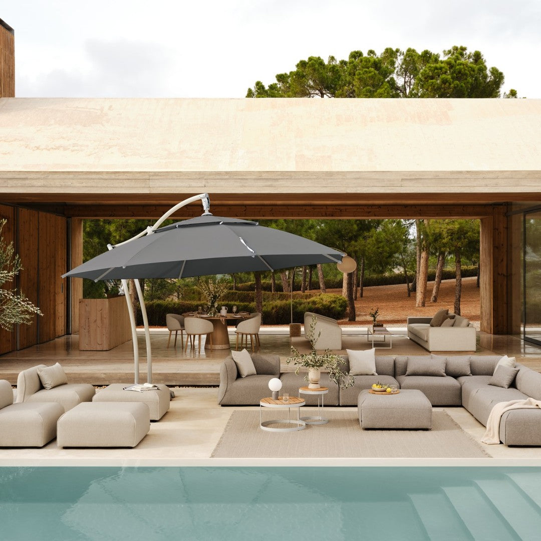 Gray outdoor umbrella over light beige lounge furniture by a pool, with neutral tones and natural textures in a modern setting.