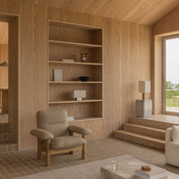 Minimalist interior with beige tones, textured patterns, natural wood shelves, and soft neutral furnishings.