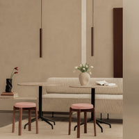 Minimalist dining set featuring beige tones, blush pink stools, and smooth, natural textures. Elegant modern decor.