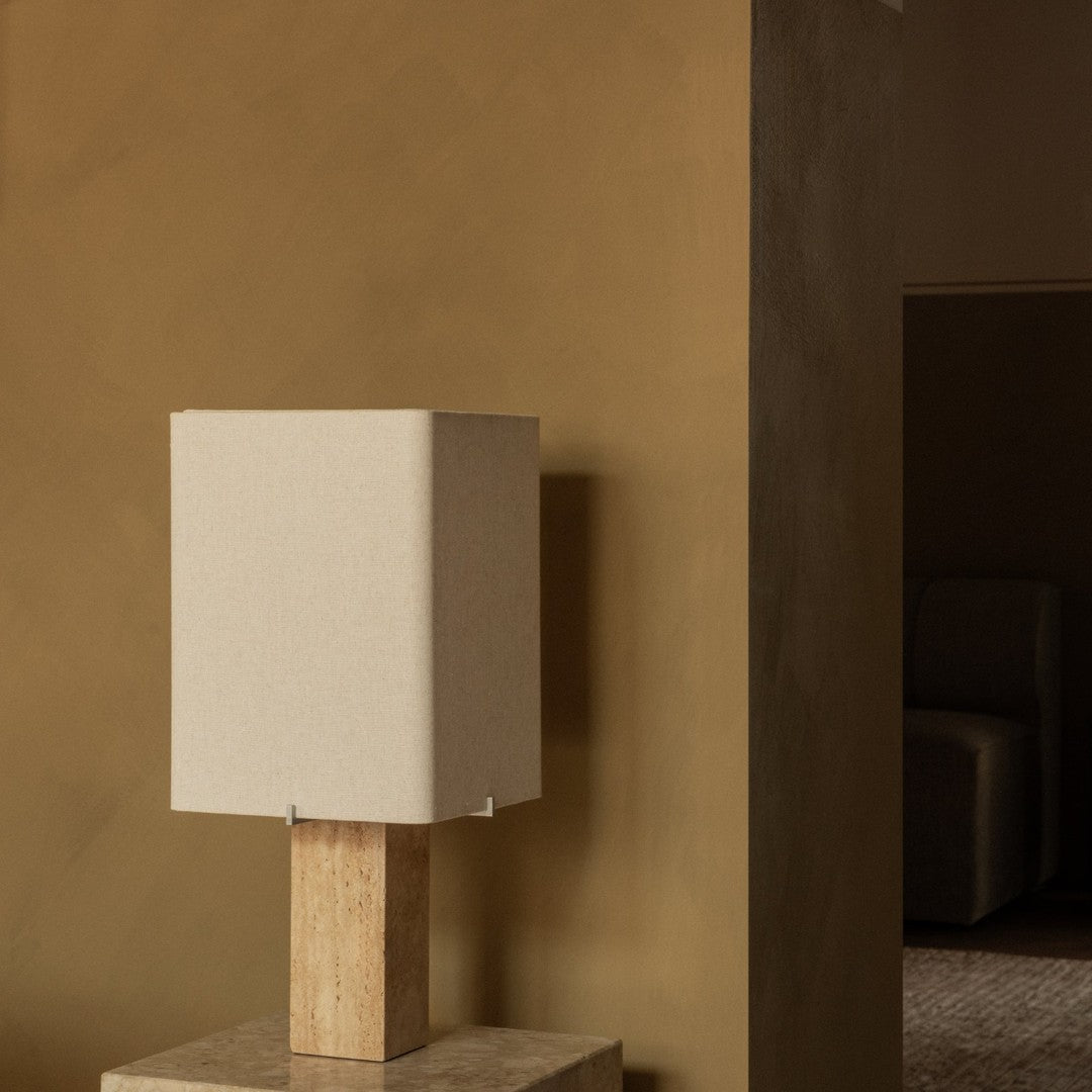 Beige square lamp with a natural wood base, set against a warm, earthy brown wall. Elegant and minimalist design.
