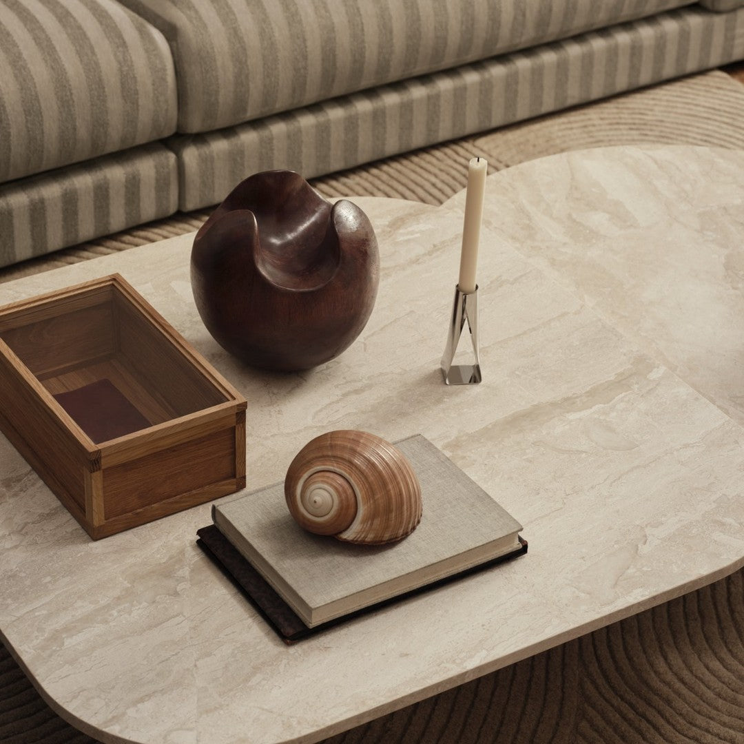 Elegant beige marble tabletop with brown wooden accents, featuring striped upholstery and natural textures.