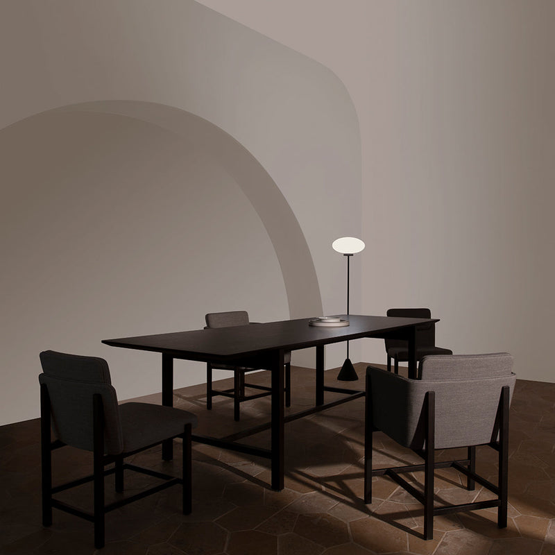 Modern furniture set in earthy tones with a sleek black table and light gray chairs, featuring minimalist design elements.
