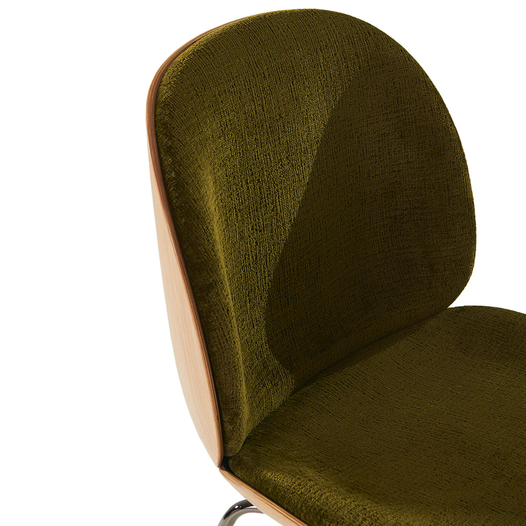Olive green textured fabric chair with a smooth wooden back and sleek metallic legs.