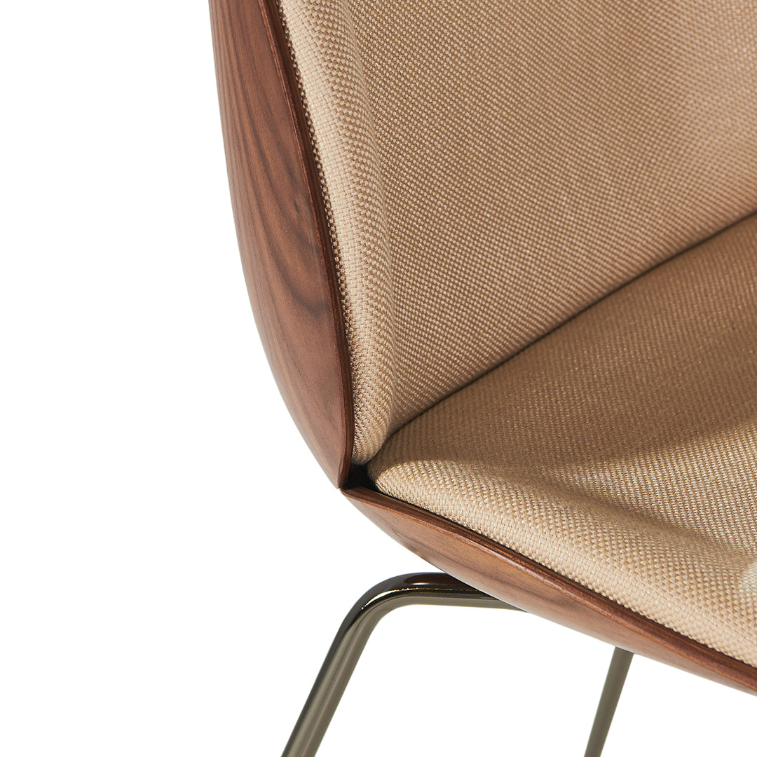 Beige fabric with textured weave, complemented by smooth walnut wood accents and a sleek metal frame.