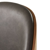 Stylish gray leather chair back with smooth texture and warm wood accent. Modern design for contemporary interiors.