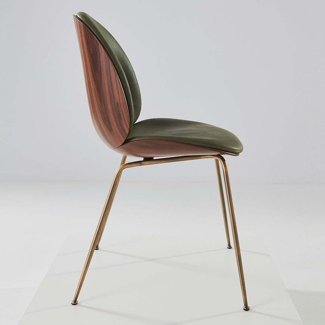 Green and walnut wood chair with a sleek, modern design and gold metal legs, showcasing natural textures and tones.