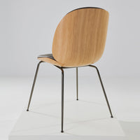 Natural wood finish with sleek black seat and minimalist black metal legs. Elegant and modern design for any space.