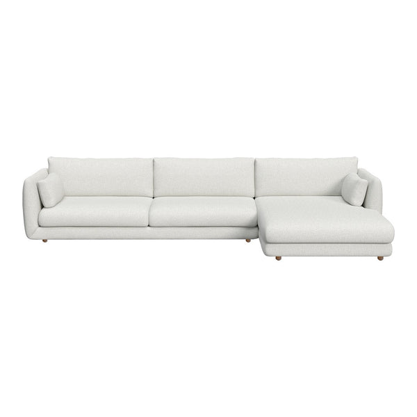 Modern white sectional sofa with sleek lines and plush cushions, featuring solid pale tones and smooth textures.
