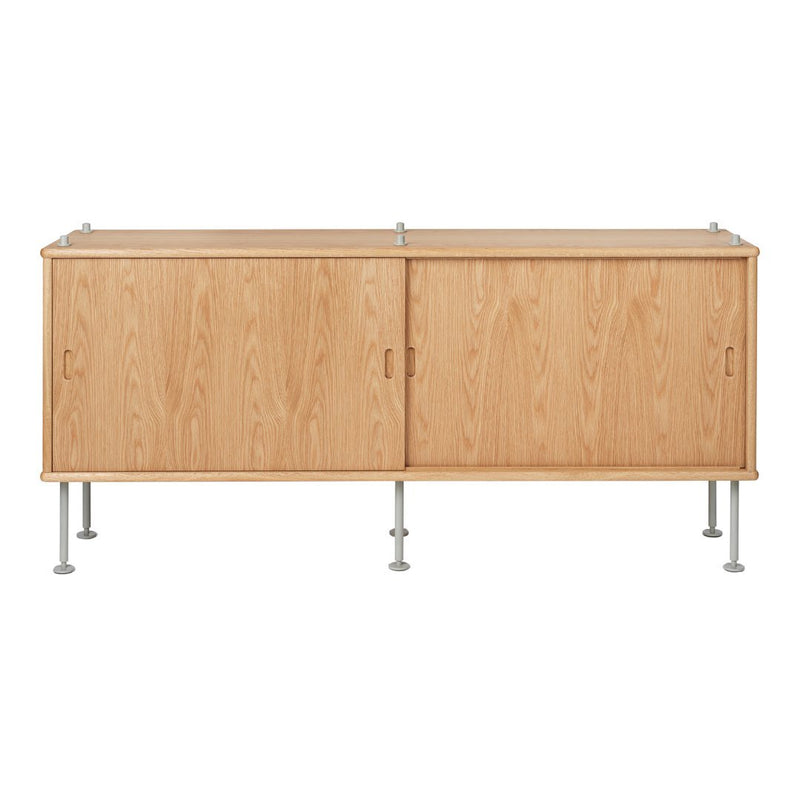 Light wood cabinet with a natural grain pattern, featuring smooth lines and metallic legs for a modern look.