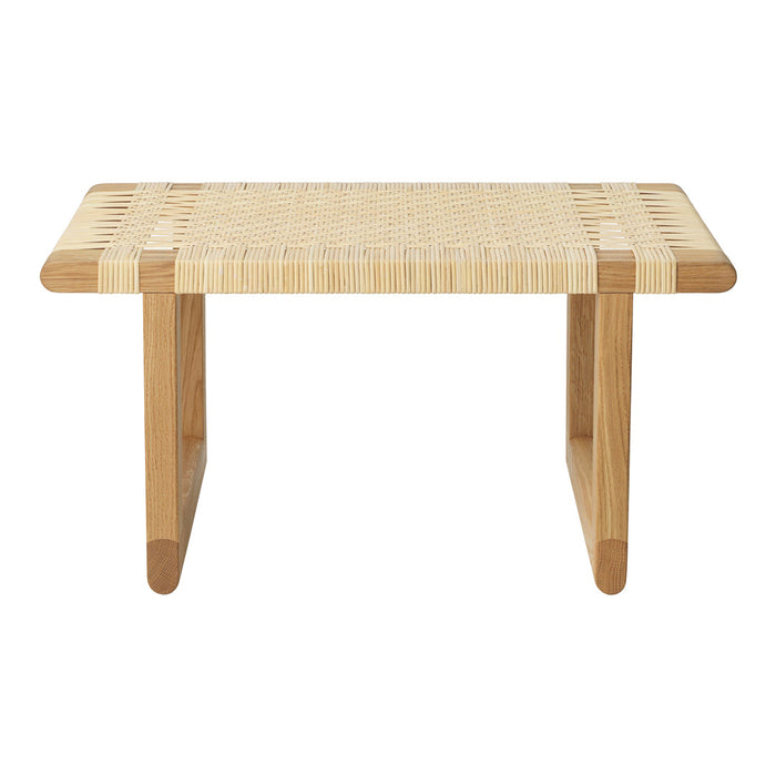Natural wood coffee table with woven light beige top and minimalistic design, featuring clean lines and earthy tones.