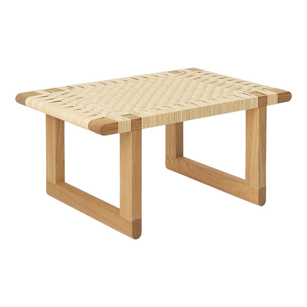 Natural wood coffee table with a light woven rattan pattern and contrasting light and dark wood legs.