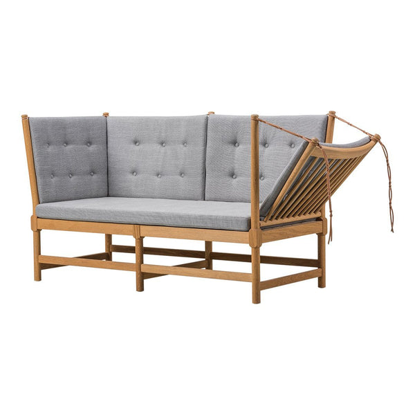 Gray tufted upholstery with light wood frame and unique slatted design, perfect for modern decor.