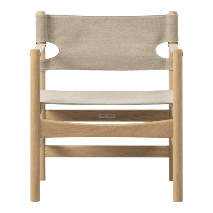 Beige fabric and light wood frame chair with minimalist design. Perfect for modern decor.