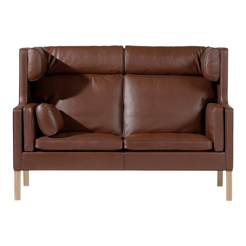 Brown leather sofa with a smooth surface and modern design, featuring simple lines and light wooden legs.