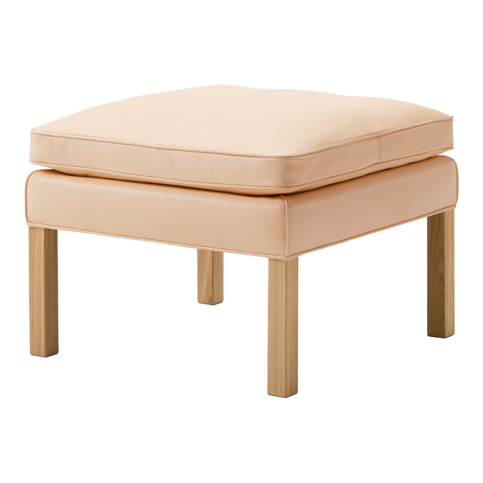 Peach-colored ottoman with a smooth surface and light wooden legs. Minimalist design, perfect for modern decor.