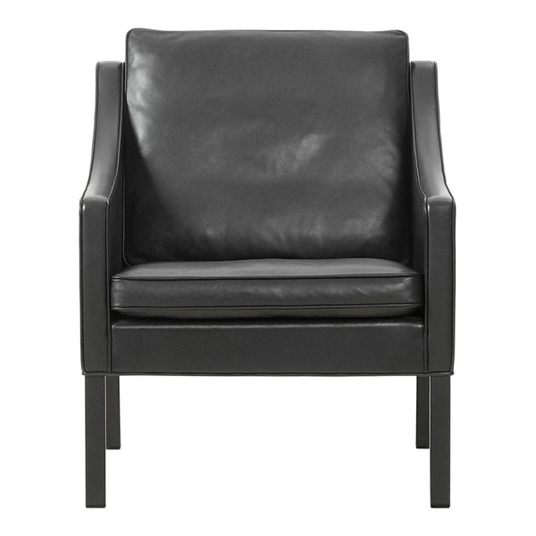 Black leather armchair with smooth texture and sleek, minimalist design. Perfect for modern decor.