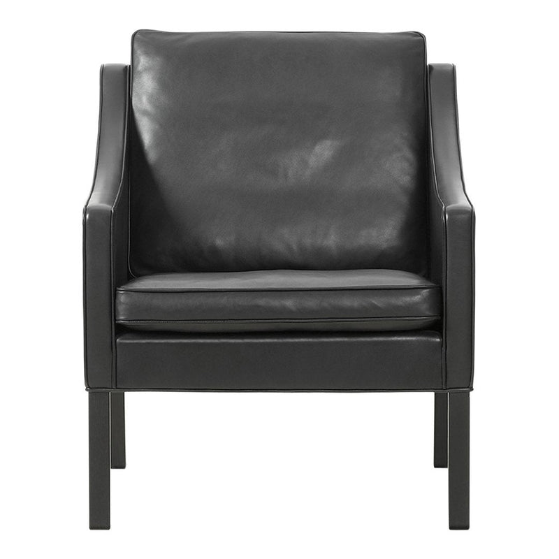 Black leather armchair with smooth texture and sleek, minimalist design. Perfect for modern decor.