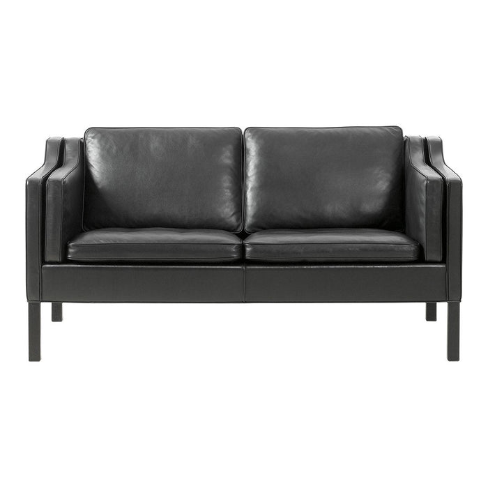 Black leather loveseat with a smooth finish and minimalist design. Classic and elegant, perfect for modern decor.