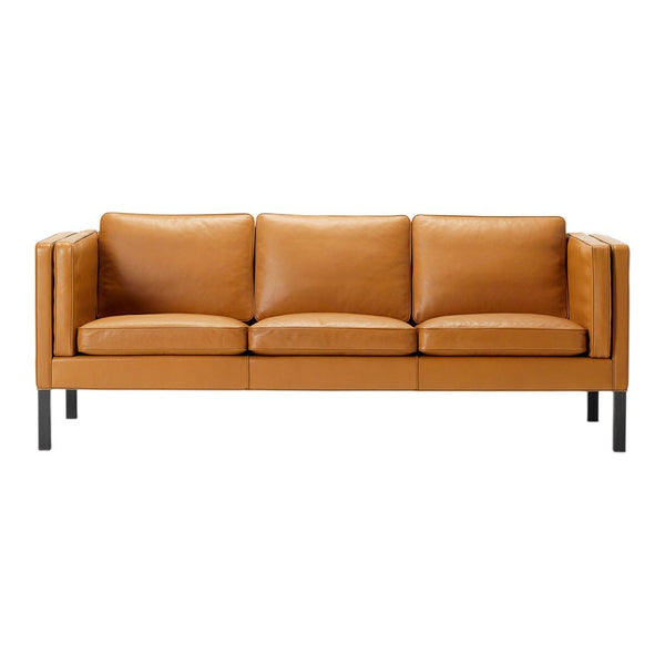 Tan leather sofa with a sleek, modern design and plush cushions, set on a black metal frame.